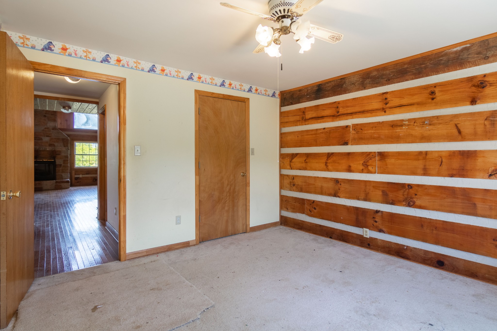 6323 Bethlehem Road Springfield, TN 37172 - Photo 20 of 30 a view of an empty room with wooden floor and a ceiling fan