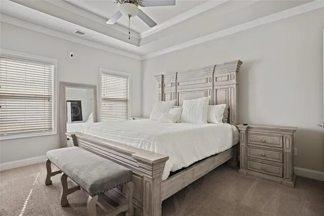 a bedroom with a bed table and chair