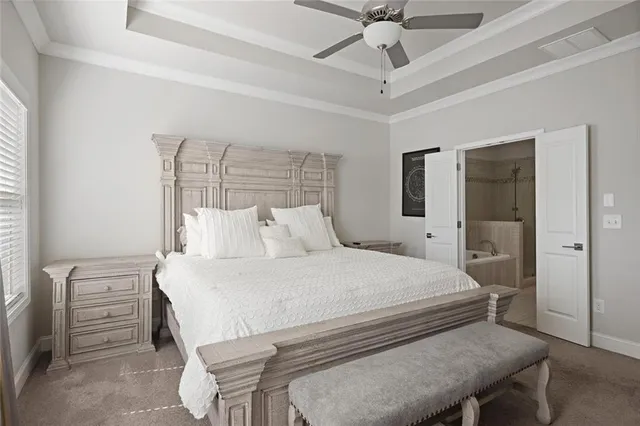 a bedroom with a bed and a chandelier