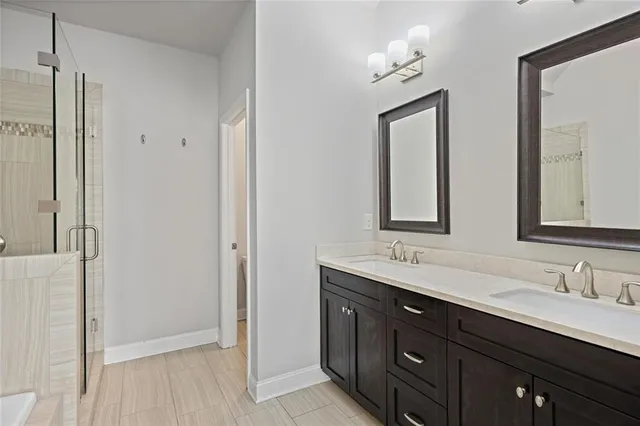 a bathroom with a double vanity sink and a mirror