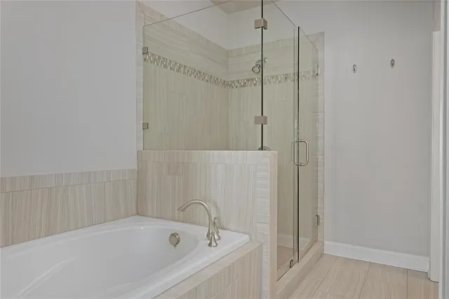a white bath tub sitting next to a shower