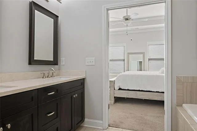 a en suite bathroom with a double vanity sink a mirror and a