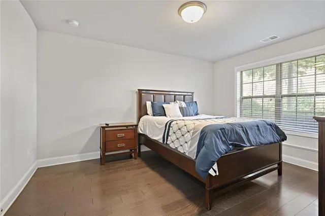 a bed sitting in a bedroom next to a window