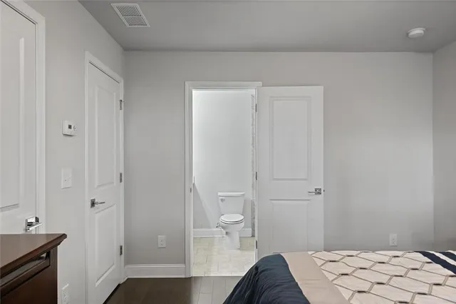 a bedroom with a bed and a view of bathroom