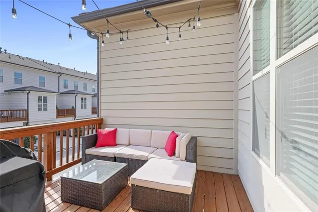 a view of a deck with couches table and chairs with wooden floor