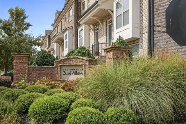 a view of a brick house with a yard