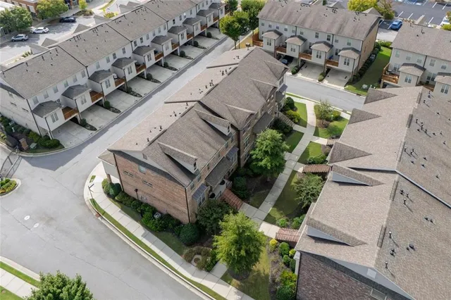 an aerial view of a house with a yard and pool