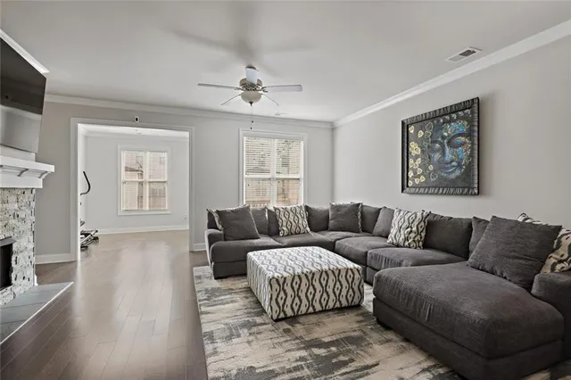 a living room with furniture a fireplace and a flat screen tv
