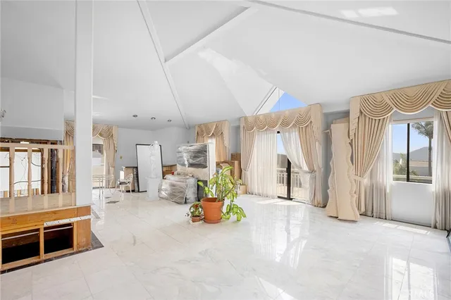 a view of a livingroom with furniture and a fireplace