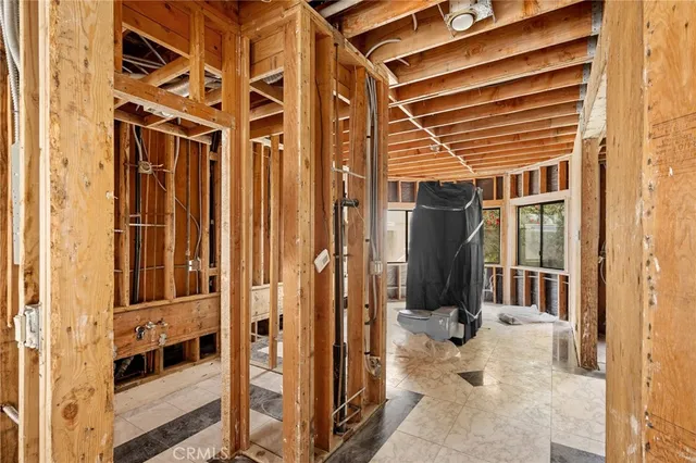 a view of a porch with wooden floor and a window