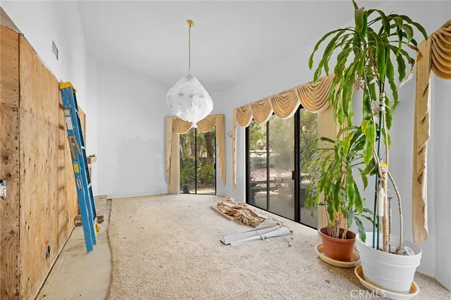 a view of a bedroom with window and furniture