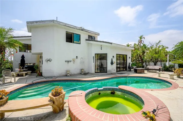 a front view of a house with sitting area