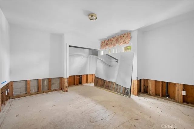 a view of an empty room with a staircase