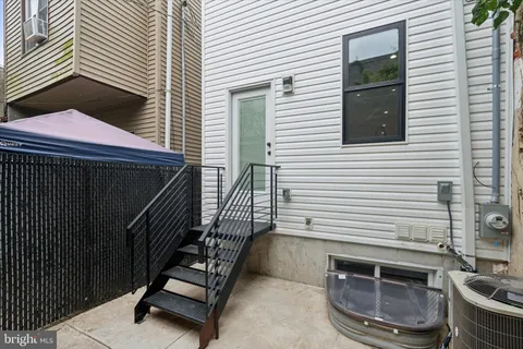 a view of a balcony with furniture and stairs