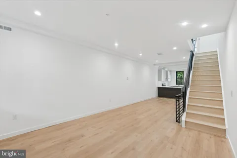 a view of livingroom with stairs and wooden floor