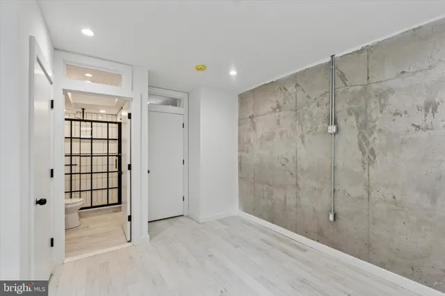 a bathroom with a shower and a glass door