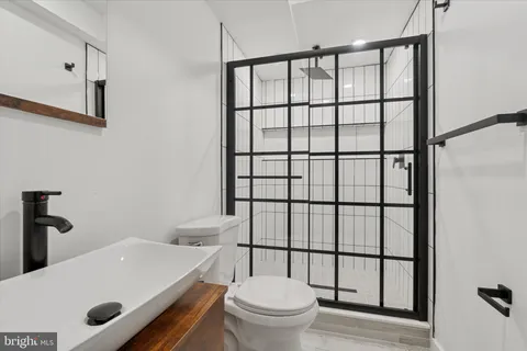 a white toilet sitting next to a bathroom sink