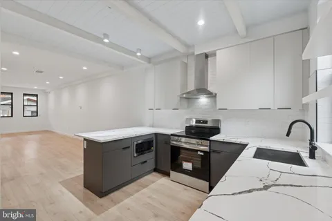 a kitchen with granite countertop a sink and a stove top oven