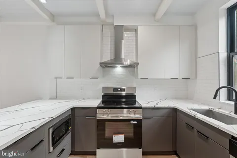 a kitchen with granite countertop a stove and a sink