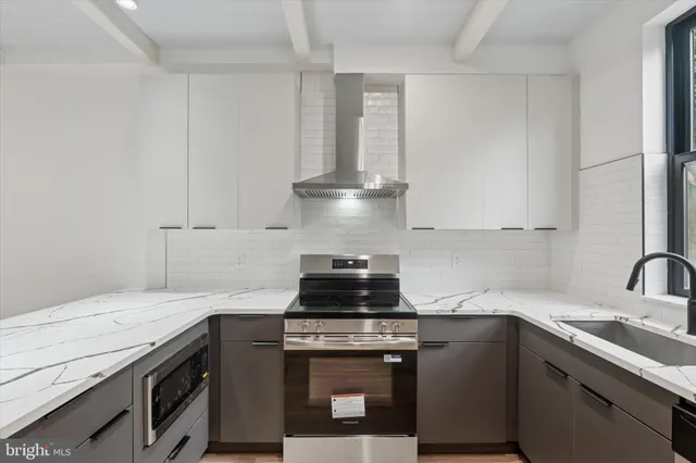 a kitchen with granite countertop a stove and a sink
