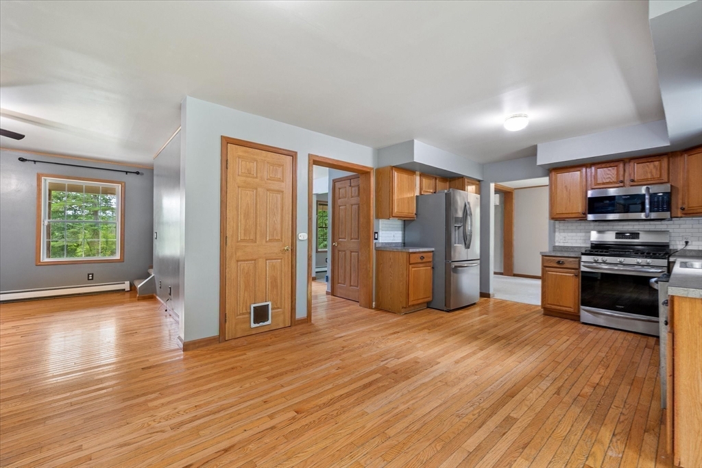 1824 Greenwich Road Hardwick, MA 01082 - Photo 12 of 41 a kitchen with stainless steel appliances a refrigerator and wooden floor