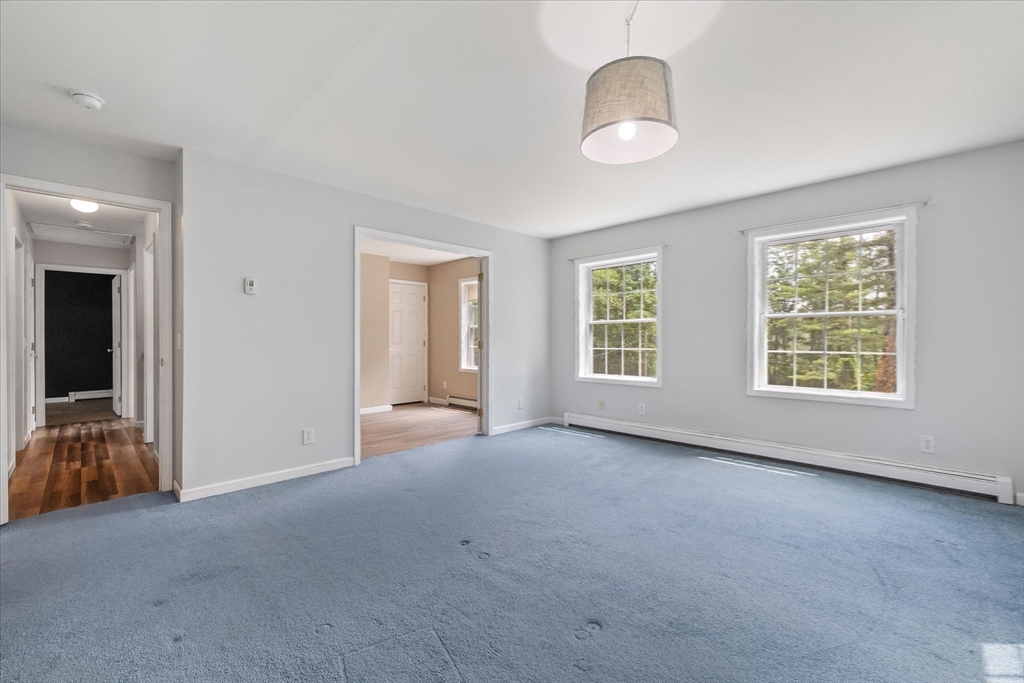 1824 Greenwich Road Hardwick, MA 01082 - Photo 19 of 41 an empty room with chandelier fan and windows