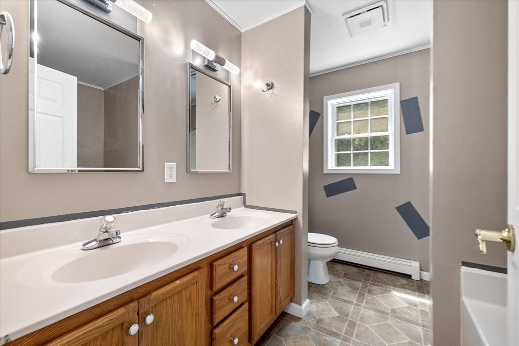1824 Greenwich Road Hardwick, MA 01082 - Photo 22 of 41 a bathroom with a double vanity sink toilet and a mirror