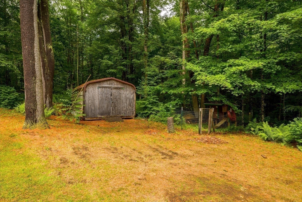 1824 Greenwich Road Hardwick, MA 01082 - Photo 37 of 41 a backyard of a house with table and chairs and wooden fence