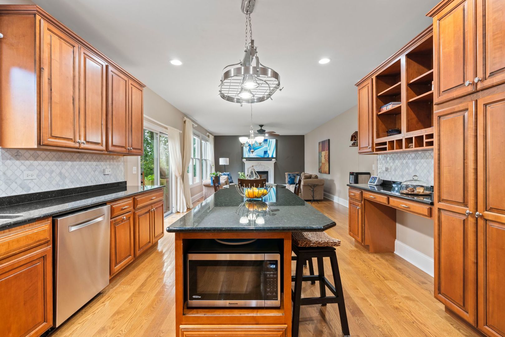 106 Forest View Drive Lake Bluff, IL 60044 - Photo 14 of 56 a kitchen with stainless steel appliances granite countertop a stove top oven a sink dishwasher and white cabinets with wooden floor