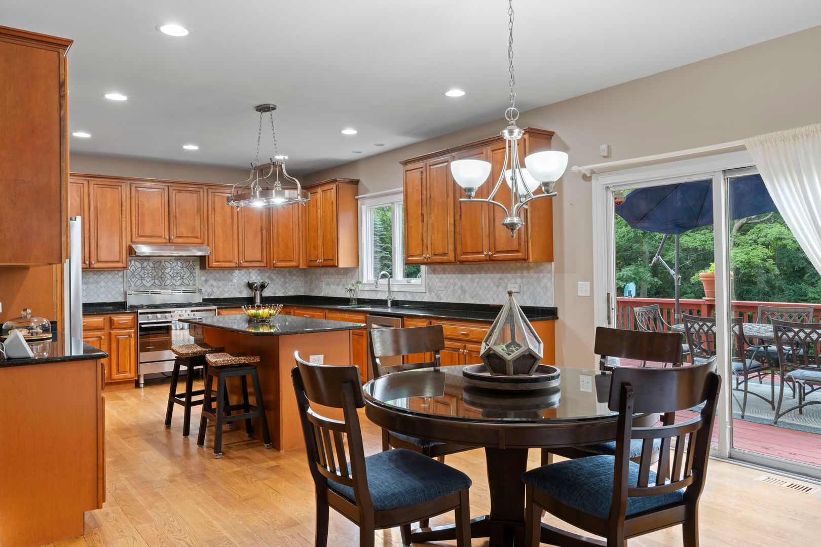 106 Forest View Drive Lake Bluff, IL 60044 - Photo 9 of 56 a kitchen with a dining table chairs and sink