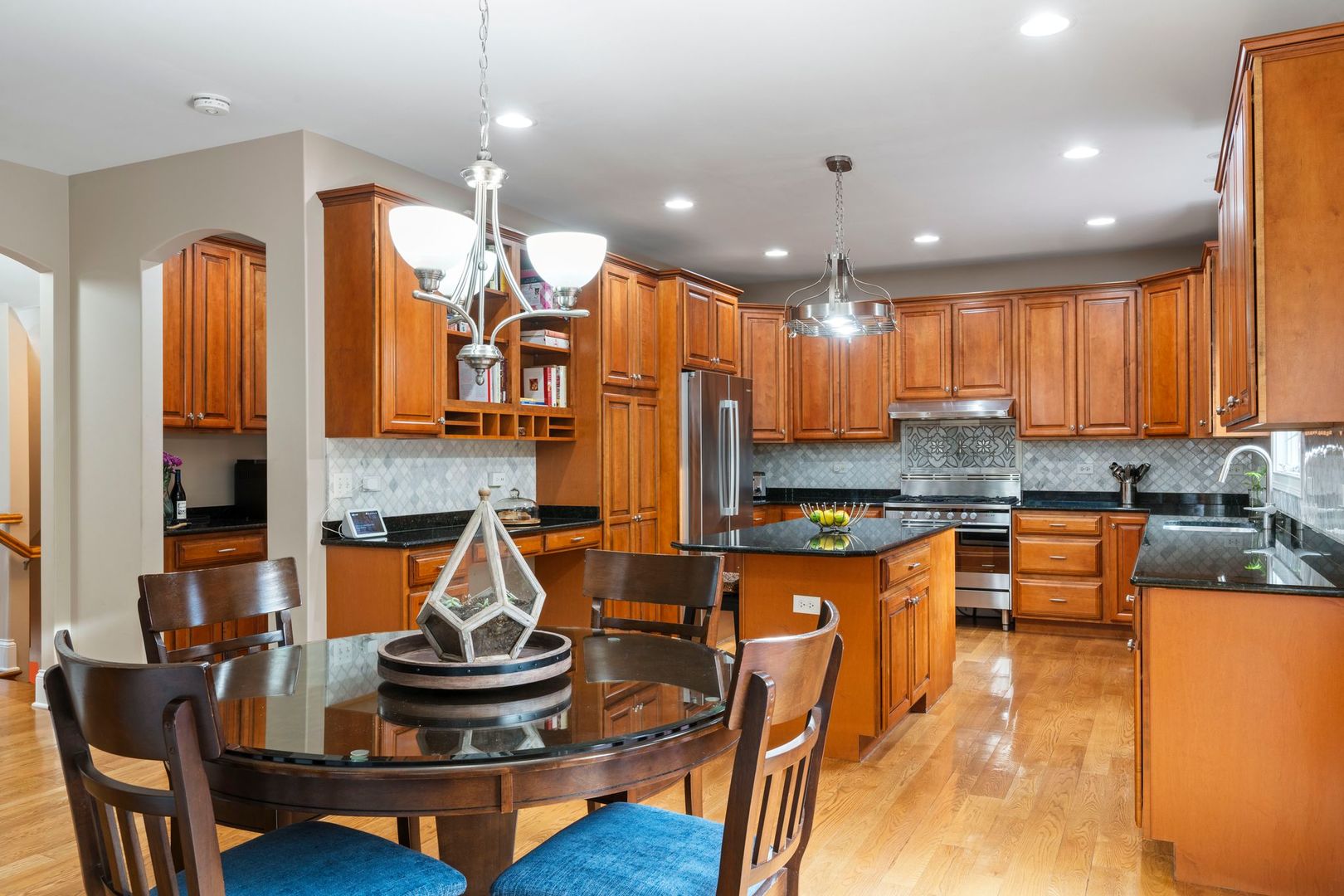 106 Forest View Drive Lake Bluff, IL 60044 - Photo 10 of 56 a kitchen with kitchen island granite countertop a stove a sink a refrigerator and chairs