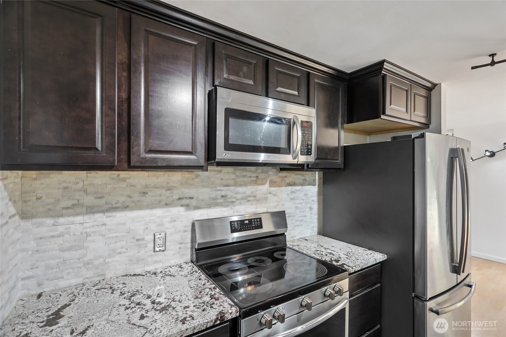 28601 Southeast 225th Street Maple Valley, WA 98038 - Photo 11 of 40 a kitchen with stainless steel appliances granite countertop a stove microwave and refrigerator