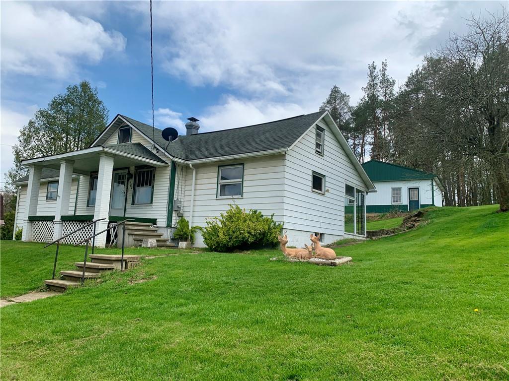100 Main Street Home, PA 15747 - Photo 1 of 25 a front view of house with a garden and plants