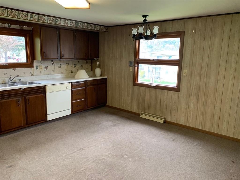 100 Main Street Home, PA 15747 - Photo 12 of 25 a kitchen with a sink window and cabinets