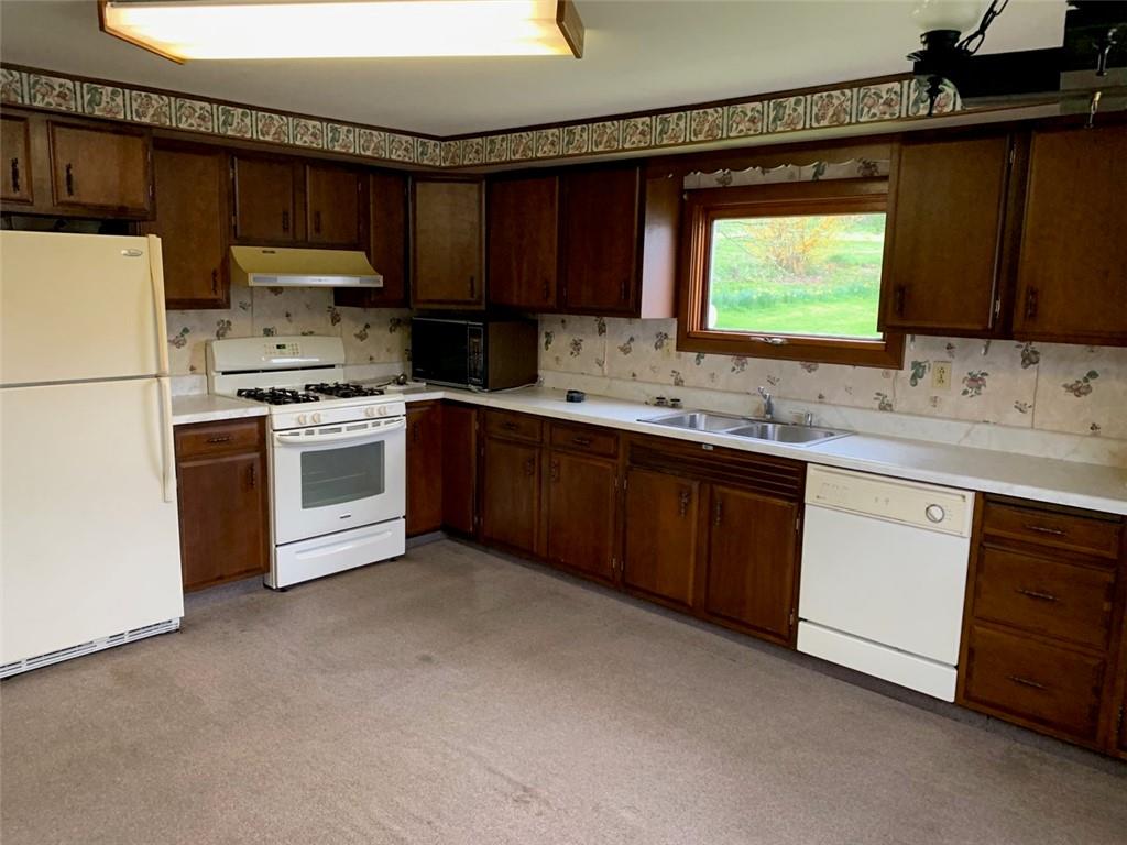 100 Main Street Home, PA 15747 - Photo 13 of 25 a kitchen with stainless steel appliances granite countertop a sink stove and refrigerator