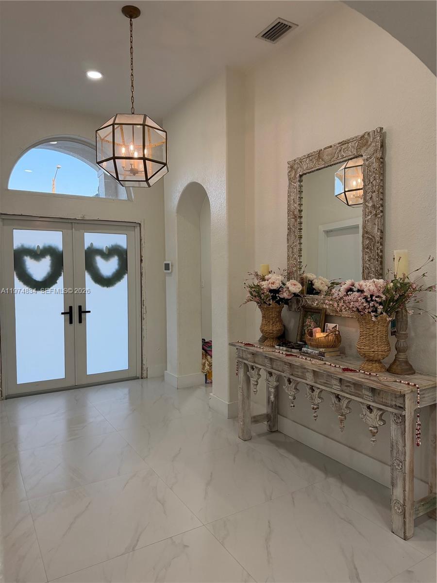 3744 Southwest 156th Court Miami, FL 33185 - Photo 3 of 13 a view of a kitchen with a sink a refrigerator and chandelier