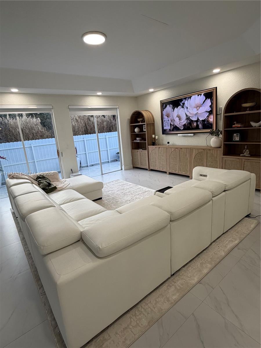 3744 Southwest 156th Court Miami, FL 33185 - Photo 6 of 13 a living room with furniture and a flat screen tv
