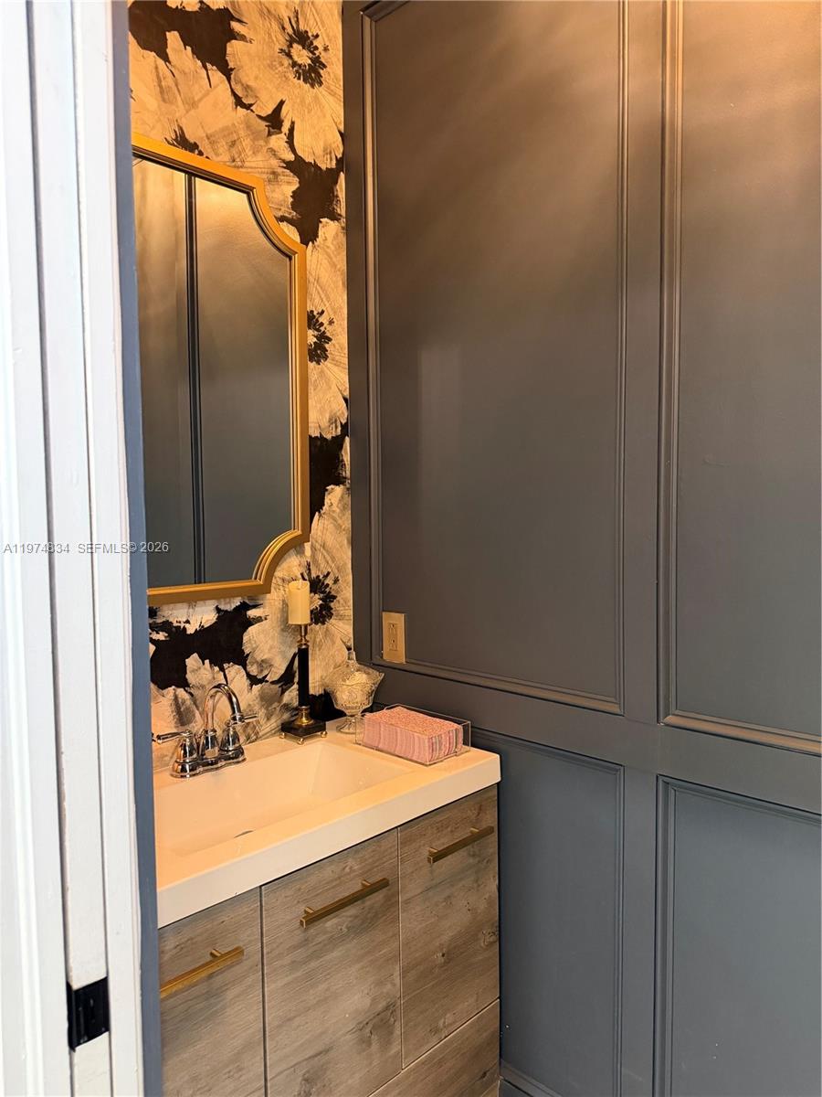 3744 Southwest 156th Court Miami, FL 33185 - Photo 7 of 13 a bathroom with a sink and mirror