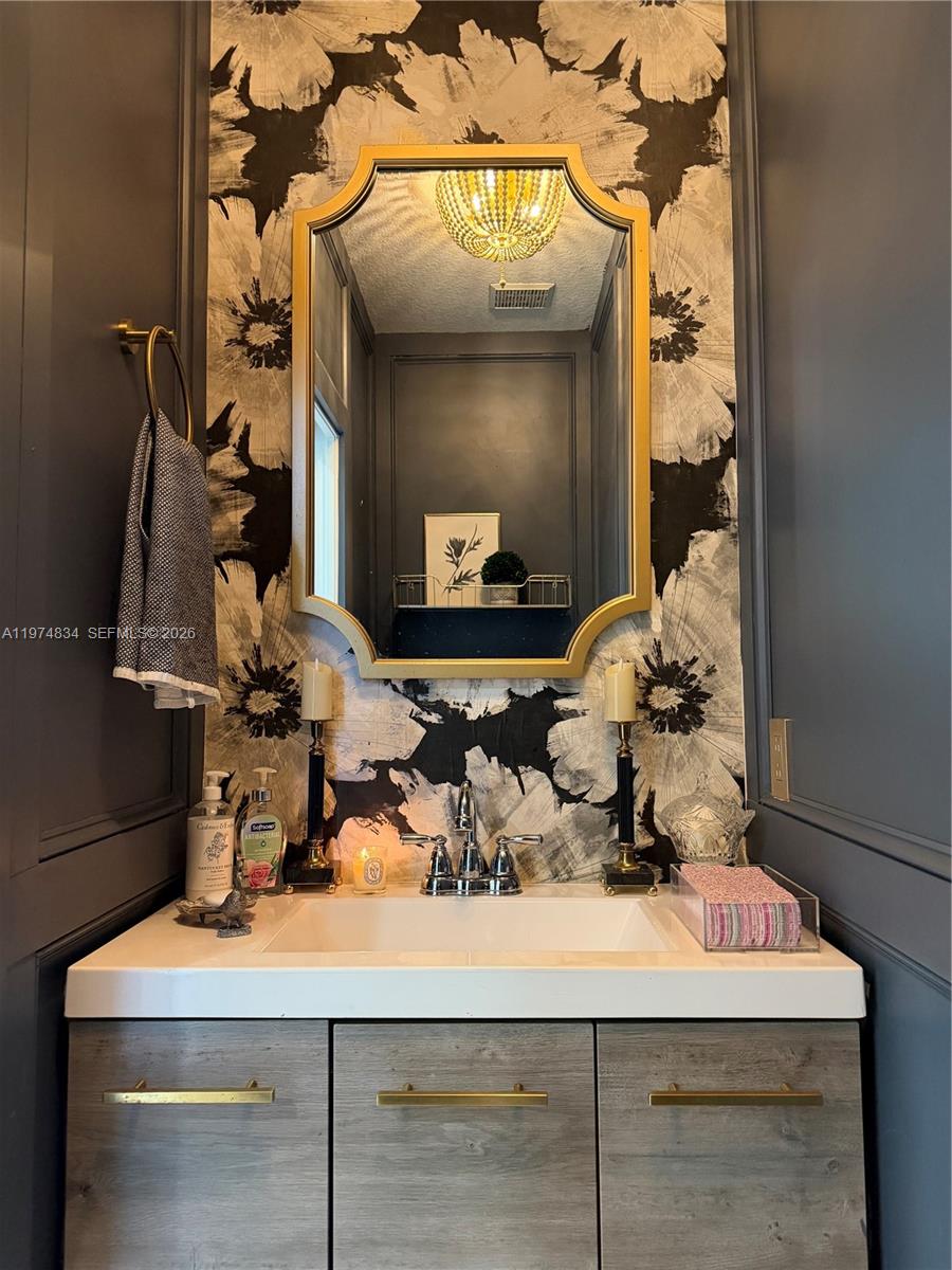 3744 Southwest 156th Court Miami, FL 33185 - Photo 8 of 13 a bathroom with a sink and a mirror