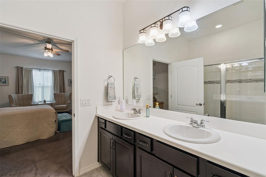 989 Maypole Drive Apopka, FL 32703 - Photo 11 of 39 a bathroom with a double vanity sink and a mirror