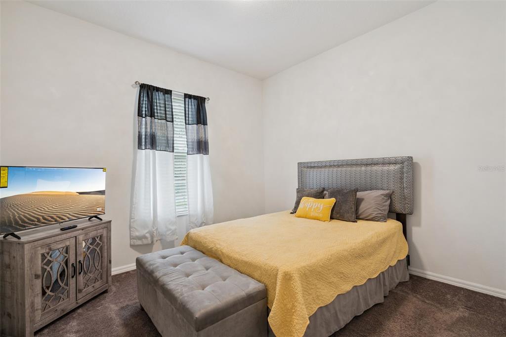 989 Maypole Drive Apopka, FL 32703 - Photo 14 of 39 a bedroom with a bed and cabinets