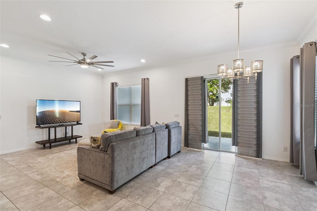989 Maypole Drive Apopka, FL 32703 - Photo 2 of 39 a living room with furniture and a chandelier