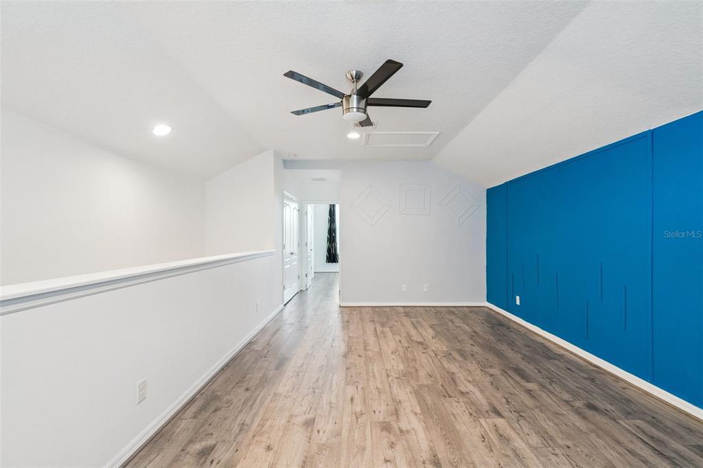 989 Maypole Drive Apopka, FL 32703 - Photo 22 of 39 a view of a hallway with wooden floor