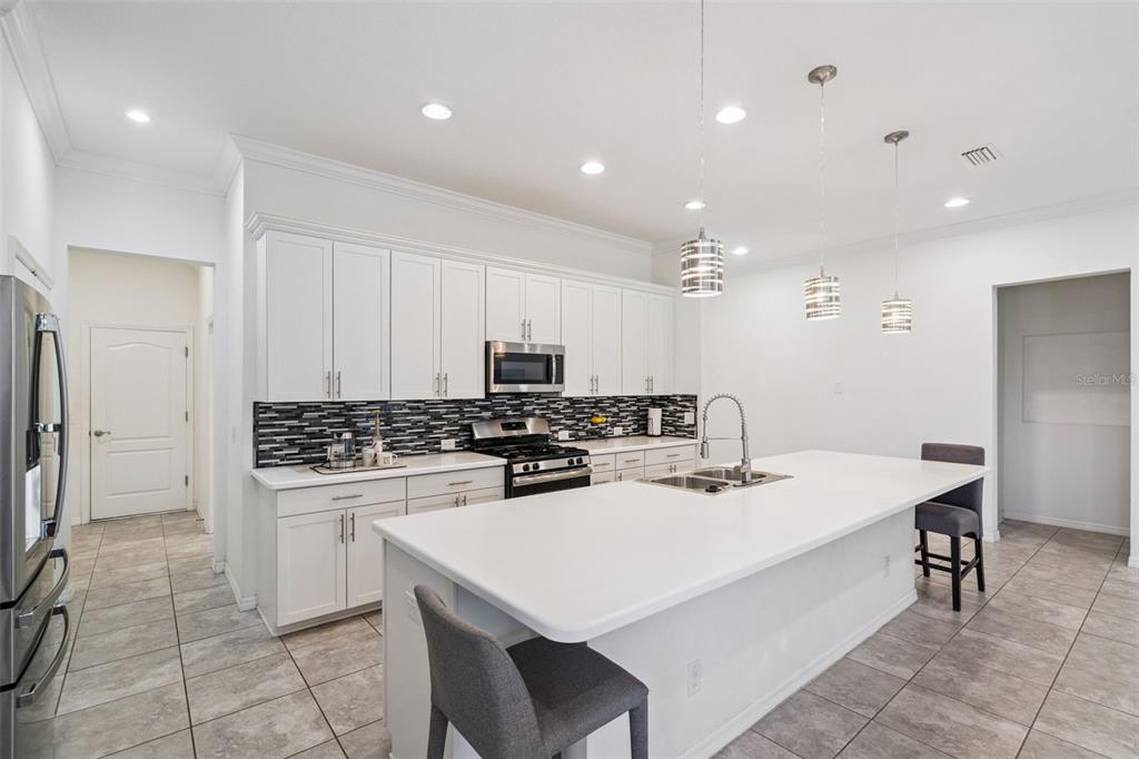989 Maypole Drive Apopka, FL 32703 - Photo 5 of 39 a kitchen with a dining table and chairs