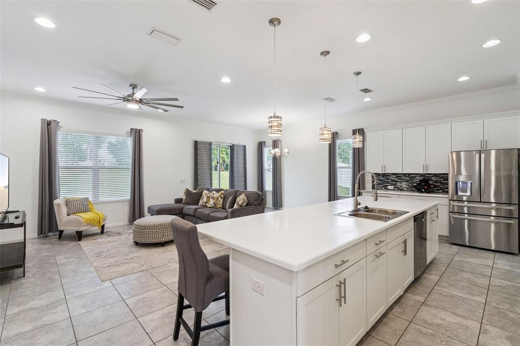 989 Maypole Drive Apopka, FL 32703 - Photo 6 of 39 a large white kitchen with a large window and stainless steel appliances