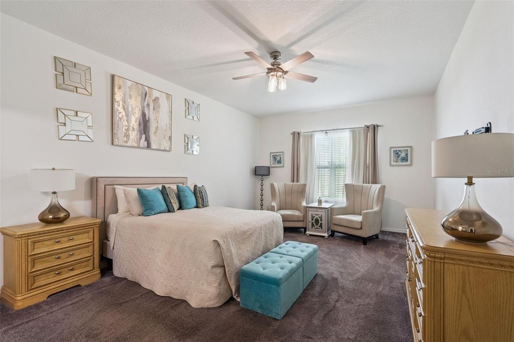 989 Maypole Drive Apopka, FL 32703 - Photo 9 of 39 a bedroom with a bed and ceiling fan