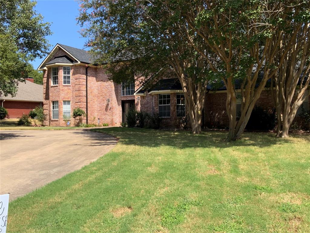 2020 Arbor Bend Road Bonham, TX 75418 - Photo 3 of 30 Brick exterior, gabled roofline, bay window, mature trees, and a paved driveway