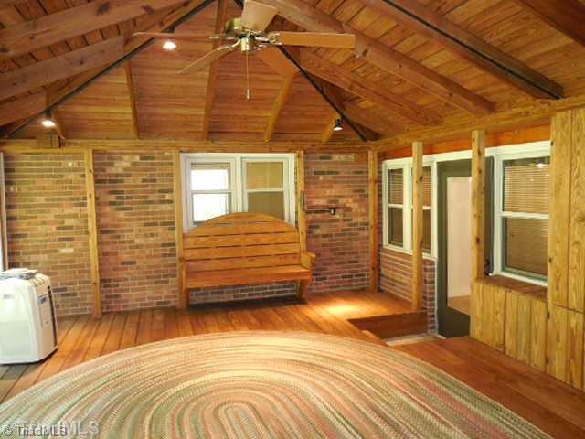 180 South Old Quarry Road Elkin, NC 28621 - Photo 14 of 16 Sunroom. The beautiful sunroom has exposed beams and ceiling to floor window.
