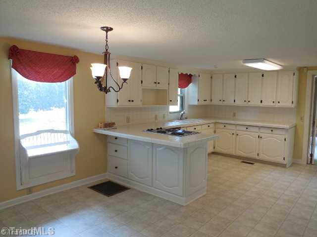 Kitchen. Beautiful open kitchen and dining area open to the vaulted great room.