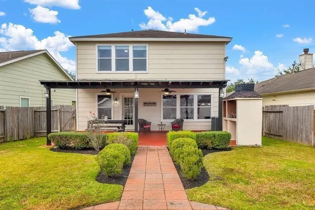 a front view of a house with a yard outdoor seating and garage
